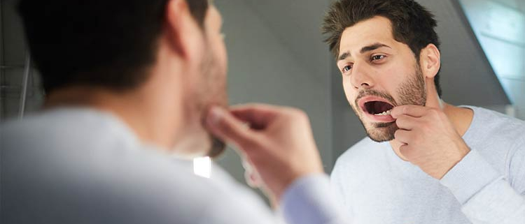 Root Canal Treatment - Man looking in the mirror - Alpha Dental Chester-le-Street
