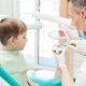 Dentist in Chester-le-Street educating little boy about brushing teeth demonstrating on dental jaw model in clinic